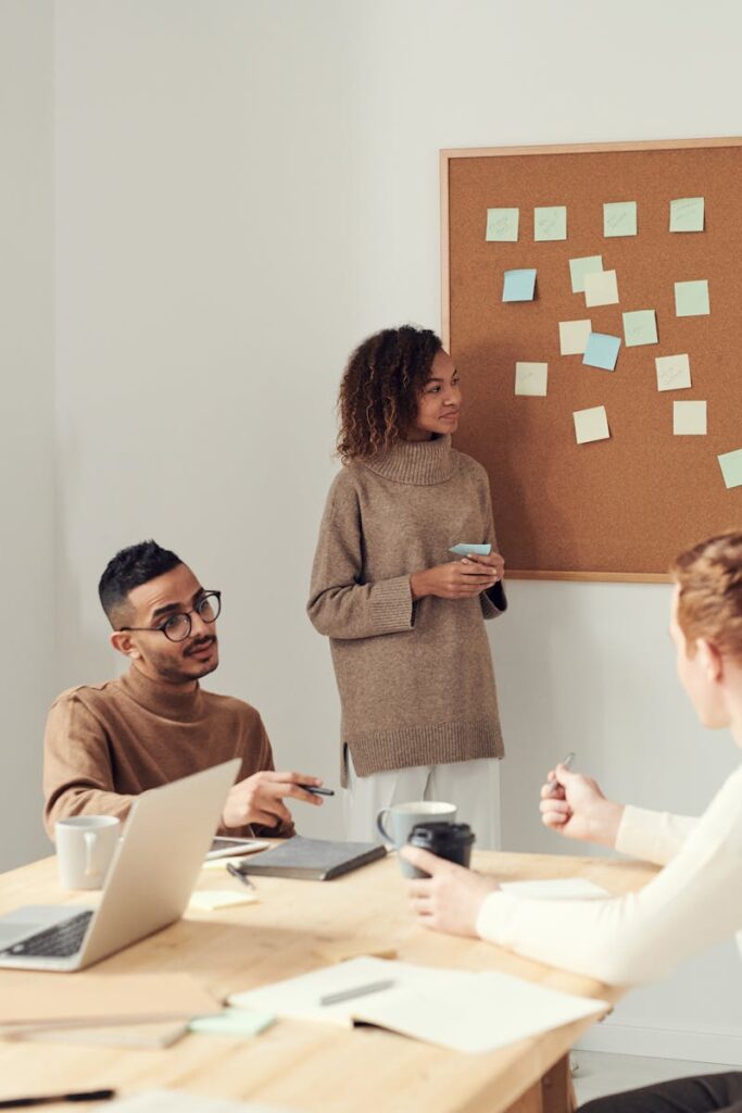 A diverse group of professionals collaborating in a modern office setting with a brainstorming session.